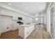 Spacious kitchen features white cabinetry, island, and stainless appliances at 1224 Penner Dr, Erie, CO 80026