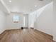 Bright living room featuring hardwood floors, large window and white walls at 1224 Penner Dr, Erie, CO 80026