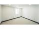 Basement bedroom featuring a window, neutral carpet, and baseboard trim at 7810 Larkwood St, Commerce City, CO 80022