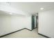 Basement area with a closet, neutral carpet, and modern trim accents at 7810 Larkwood St, Commerce City, CO 80022