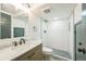 Modern bathroom featuring a white subway tiled shower and light wood vanity at 7810 Larkwood St, Commerce City, CO 80022