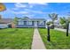 Charming blue home with a well-maintained front yard and inviting walkway at 7810 Larkwood St, Commerce City, CO 80022