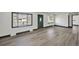Inviting living room with bay windows and stylish, updated flooring at 7810 Larkwood St, Commerce City, CO 80022