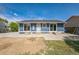 Home exterior featuring a blue paint job and concrete patio area at 7810 Larkwood St, Commerce City, CO 80022