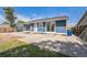 Home exterior with a blue paint job, new concrete patio area and trash can at 7810 Larkwood St, Commerce City, CO 80022
