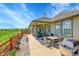 Outdoor patio with stainless steel grill, dining table and views of green pastures at 6670 Club Villa Rd, Parker, CO 80134