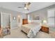 Cozy bedroom with a ceiling fan, neutral tones, and an ensuite bathroom at 6670 Club Villa Rd, Parker, CO 80134