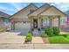 Well-maintained home with a two-car garage, covered porch, and manicured lawn at 6670 Club Villa Rd, Parker, CO 80134