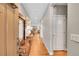 Inviting hallway with hardwood floors, leading to a living area with a fireplace at 6670 Club Villa Rd, Parker, CO 80134