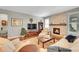 Cozy living room featuring a fireplace, hardwood floors, and comfortable seating arrangement at 6670 Club Villa Rd, Parker, CO 80134
