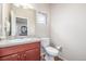 A light filled half bathroom features sleek fixtures and a modern vanity with great finishes at 19407 E Radcliff Pl, Aurora, CO 80015