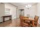 Dining room featuring hardwood flooring, wood table and seating, open to the living spaces at 19407 E Radcliff Pl, Aurora, CO 80015