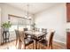 Bright dining room features hardwood floors, chandelier, and large window providing plenty of natural light at 19407 E Radcliff Pl, Aurora, CO 80015