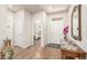 Bright entryway with hardwood floors, white doors, and a view into the bedroom, offers a welcoming ambiance at 19407 E Radcliff Pl, Aurora, CO 80015