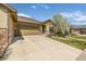 Well-manicured front yard with a flowering tree complements the charming exterior of this inviting ranch at 19407 E Radcliff Pl, Aurora, CO 80015