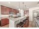Kitchen features stainless steel appliances, granite countertops, and a breakfast bar with seating at 19407 E Radcliff Pl, Aurora, CO 80015