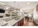 Modern kitchen with granite countertops, stainless steel appliances and view into a lovely dining area at 19407 E Radcliff Pl, Aurora, CO 80015