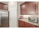 A well-organized kitchen with stainless steel appliances, granite countertops, and ample storage space at 19407 E Radcliff Pl, Aurora, CO 80015