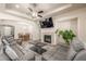 Spacious living area with tile fireplace, open design, and comfortable seating, perfect for relaxation and entertaining at 19407 E Radcliff Pl, Aurora, CO 80015
