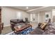 Comfortable living room featuring a leather couch, area rug, and a convenient layout with views to other rooms at 19407 E Radcliff Pl, Aurora, CO 80015