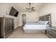 Comfortable main bedroom with stylish furnishings, a ceiling fan and a television at 19407 E Radcliff Pl, Aurora, CO 80015