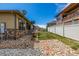 A well manicured yard features a home with stone accents and a lovely back patio at 19407 E Radcliff Pl, Aurora, CO 80015