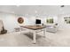 Finished basement with carpet, a ping pong table, and a comfortable seating area at 12032 Triple Crown Dr, Parker, CO 80134