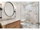 Modern bathroom with marble vanity, sleek lighting, and glass-enclosed shower at 12032 Triple Crown Dr, Parker, CO 80134