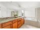 Luxurious bathroom with granite countertops, double sinks, soaking tub, and tiled shower at 12032 Triple Crown Dr, Parker, CO 80134