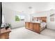 Bedroom with wooden bed, carpet, and natural light from several windows at 12032 Triple Crown Dr, Parker, CO 80134