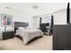 Well-lit bedroom with dark wood bed frame, desk, carpeting, and natural light at 12032 Triple Crown Dr, Parker, CO 80134