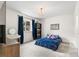 Charming bedroom with blue accents, vanity, chandelier and natural light at 12032 Triple Crown Dr, Parker, CO 80134