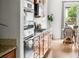 Gourmet kitchen featuring stainless steel ovens, granite counters, wood cabinets, and hardwood floors at 12032 Triple Crown Dr, Parker, CO 80134