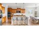 Open kitchen with an island, granite countertops, pendant lighting, and counter seating at 12032 Triple Crown Dr, Parker, CO 80134