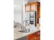Close-up of a kitchen island sink with granite countertop, stainless steel appliances, and wood cabinetry at 12032 Triple Crown Dr, Parker, CO 80134