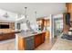 Modern kitchen with wood cabinets, stainless steel appliances, granite counters, island, and bar seating at 12032 Triple Crown Dr, Parker, CO 80134