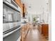 Gourmet kitchen featuring stainless steel ovens, granite counters, wood cabinets, and hardwood floors at 12032 Triple Crown Dr, Parker, CO 80134