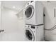Convenient laundry room with stacked washer and dryer units, offering space-saving design at 12032 Triple Crown Dr, Parker, CO 80134