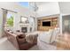 Elegant living room boasts a fireplace, large windows, hardwood floors, and ample natural light at 12032 Triple Crown Dr, Parker, CO 80134