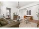 Bright living room with hardwood floors, plantation shutters, a stylish rug, and elegant decor at 12032 Triple Crown Dr, Parker, CO 80134