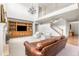 Spacious living room with a high ceiling, wooden entertainment center, and staircase at 12032 Triple Crown Dr, Parker, CO 80134