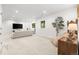 Open-concept living room with comfortable seating, media center, and natural light at 12032 Triple Crown Dr, Parker, CO 80134