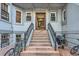 Apartment building entryway with staircase, wrought iron railings, and brick accents, inviting and secure at 215 E 11Th Ave # B9, Denver, CO 80203