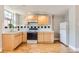 Apartment kitchen featuring bright wood cabinets, modern appliances, and hardwood floors, offering style and functionality at 215 E 11Th Ave # B9, Denver, CO 80203