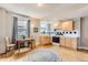 Bright apartment kitchen features light wood cabinets, modern appliances, and cozy breakfast nook with hardwood floors at 215 E 11Th Ave # B9, Denver, CO 80203