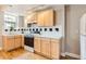 Bright kitchen featuring light cabinets, black and white tiled backsplash, and modern appliances on hardwood floors at 215 E 11Th Ave # B9, Denver, CO 80203