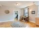 Living room featuring neutral walls, hardwood floors, and a decorative rug under a wooden table set with chairs at 215 E 11Th Ave # B9, Denver, CO 80203