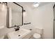 Clean bathroom with a modern sink, toilet, and framed mirror at 10707 W Cooper Dr, Littleton, CO 80127