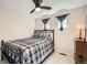 Clean bedroom with ceiling fan, and windows with grey curtains at 10707 W Cooper Dr, Littleton, CO 80127