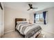 Bright bedroom with ceiling fan, and window with blue curtains at 10707 W Cooper Dr, Littleton, CO 80127